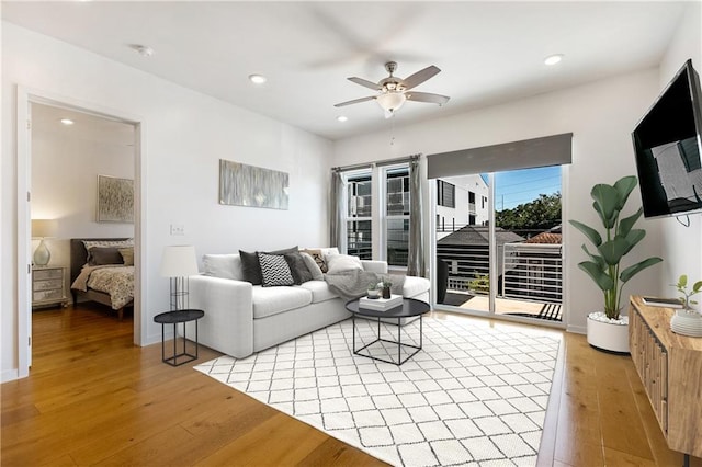 living area featuring ceiling fan, light wood-style flooring, and recessed lighting