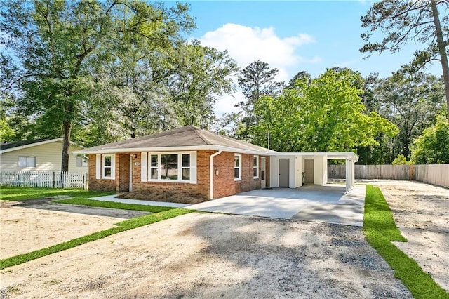 1615 Trechel Dr, Covington, LA 70433 - view of front of home with fence, an attached carport, brick siding, and driveway