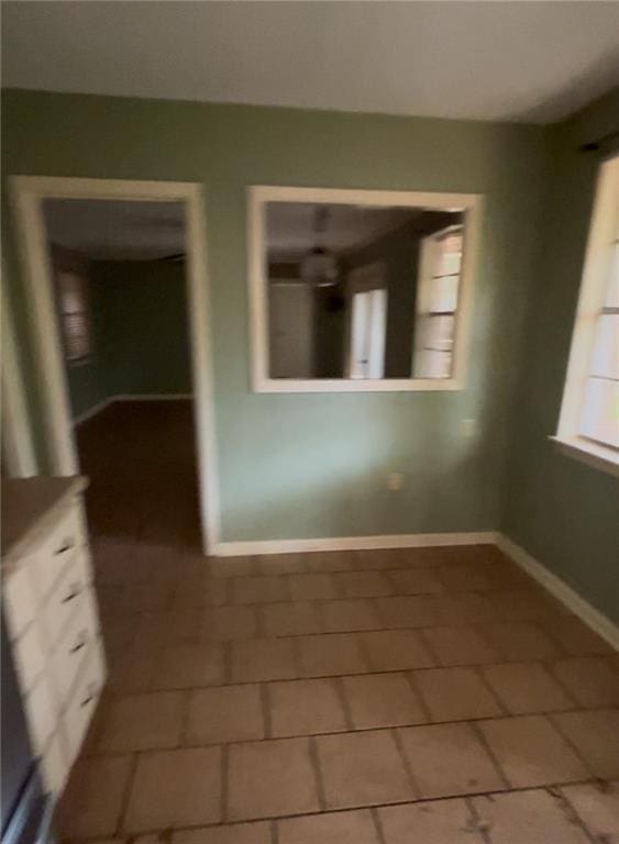 unfurnished room with baseboards