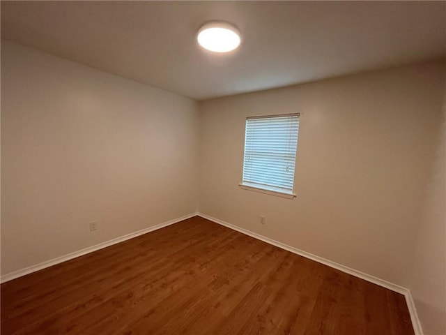 1053 Sandalwood Dr, Harvey, LA 70058 - unfurnished room with baseboards and dark wood-style flooring