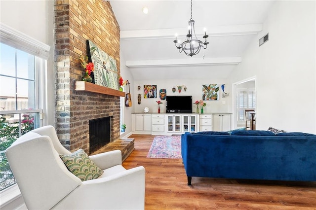 47 Yellowstone Dr, New Orleans, LA 70131 - living area with a chandelier, a fireplace, and wood finished floors