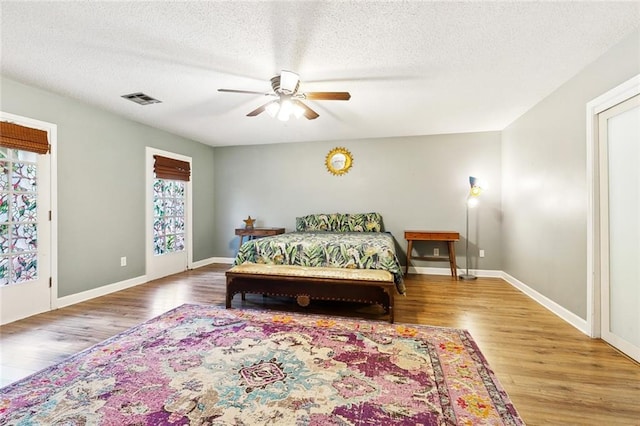 47 Yellowstone Dr, New Orleans, LA 70131 - bedroom featuring wood finished floors, a textured ceiling, baseboards, and a ceiling fan