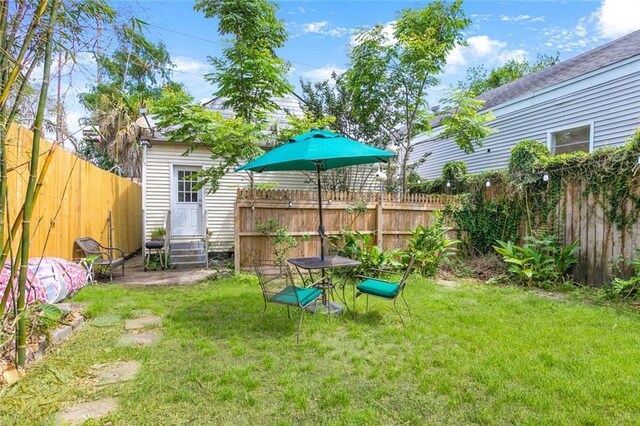 view of yard with entry steps and a fenced backyard