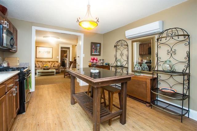 dining space featuring light wood-style floors and a wall mounted air conditioner