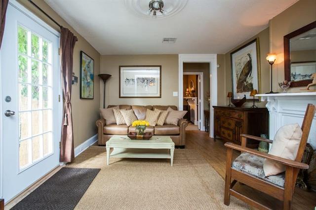 living area with baseboards and visible vents