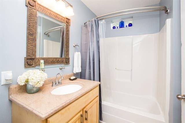 full bathroom featuring vanity and shower / tub combo
