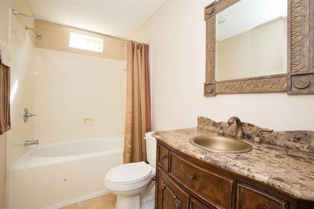 bathroom with tile patterned floors, vanity, toilet, and shower / bath combo