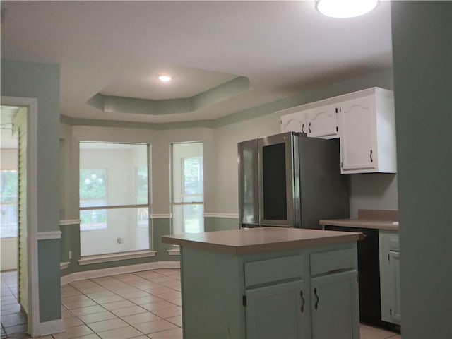 20102 Garland St, Covington, LA 70435 - kitchen with smart refrigerator, white cabinetry, a tray ceiling, light tile patterned floors, and light countertops