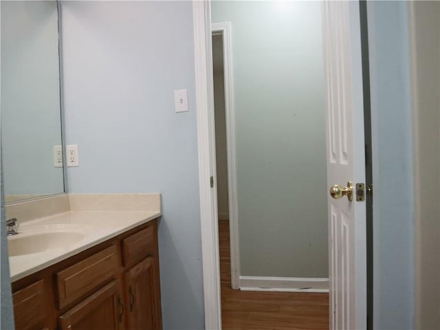 20102 Garland St, Covington, LA 70435 - bathroom featuring vanity, wood finished floors, and baseboards