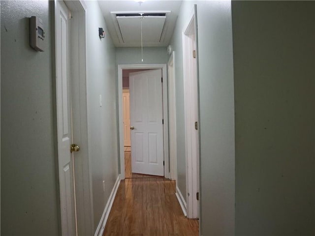 20102 Garland St, Covington, LA 70435 - hall featuring attic access, wood finished floors, and baseboards
