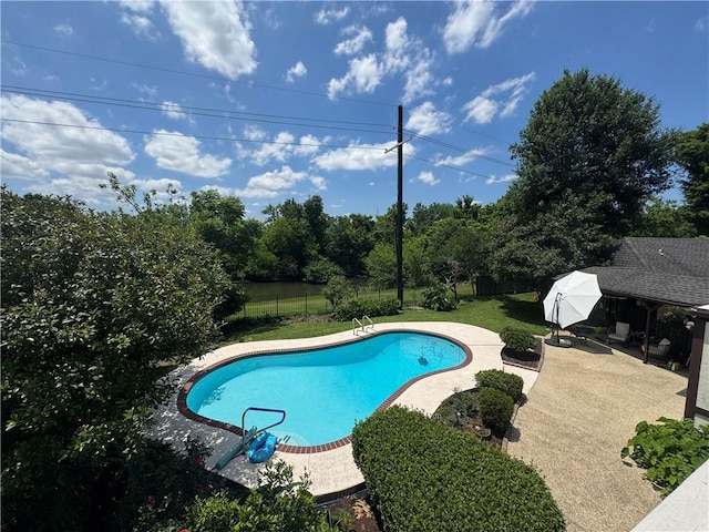 view of pool featuring a patio, fence, a lawn, and a fenced in pool