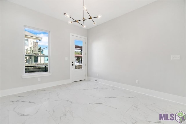 interior space with baseboards, marble finish floor, and a notable chandelier