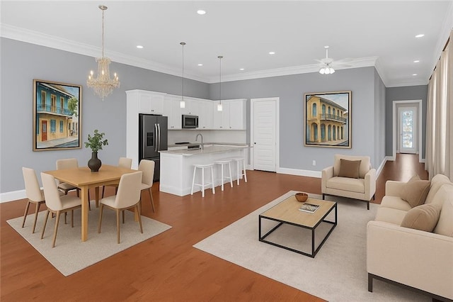 2540 Saint Ann St, New Orleans, LA 70119 - living room with baseboards, dark wood-type flooring, a ceiling fan, recessed lighting, and a chandelier