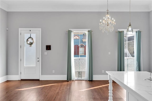 2540 Saint Ann St, New Orleans, LA 70119 - entrance foyer with a chandelier, wood finished floors, baseboards, and ornamental molding