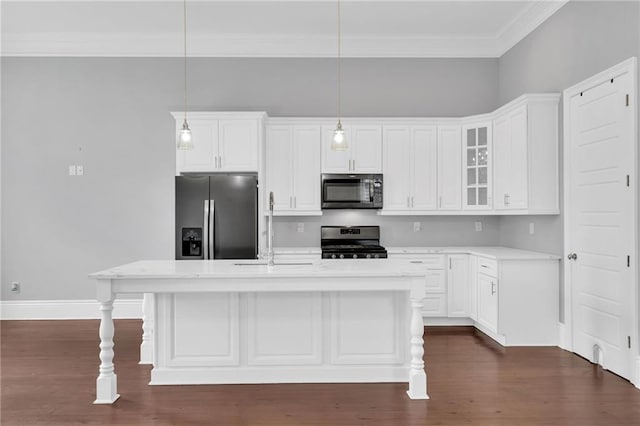 2540 Saint Ann St, New Orleans, LA 70119 - kitchen with stainless steel appliances, light countertops, a kitchen island with sink, glass insert cabinets, and white cabinetry