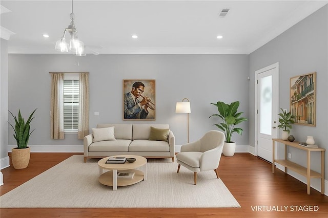 2540 Saint Ann St, New Orleans, LA 70119 - living area featuring plenty of natural light, ornamental molding, wood finished floors, baseboards, and recessed lighting