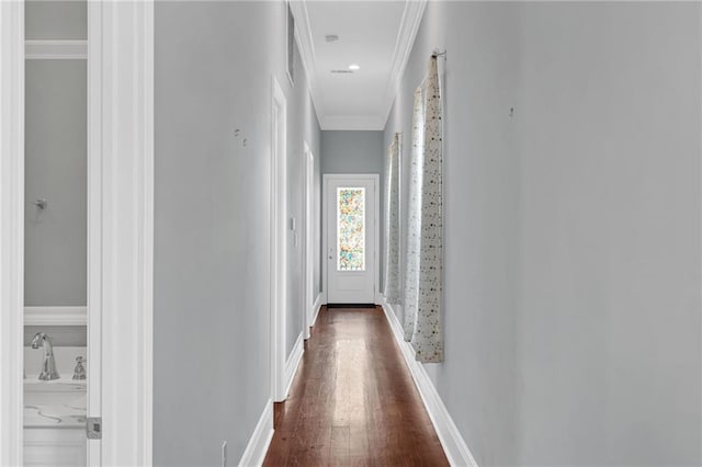2540 Saint Ann St, New Orleans, LA 70119 - hallway featuring ornamental molding, dark wood-type flooring, and baseboards