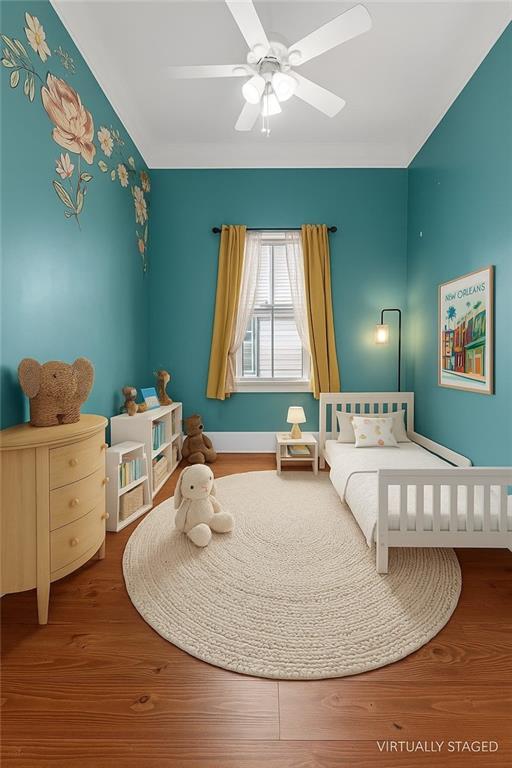 2540 Saint Ann St, New Orleans, LA 70119 - bedroom with wood finished floors and ceiling fan