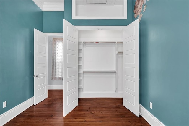 2540 Saint Ann St, New Orleans, LA 70119 - unfurnished bedroom with baseboards, dark wood finished floors, a closet, and ornamental molding