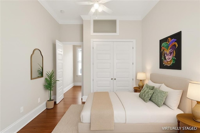 2540 Saint Ann St, New Orleans, LA 70119 - bedroom with crown molding, a closet, dark wood finished floors, baseboards, and a ceiling fan