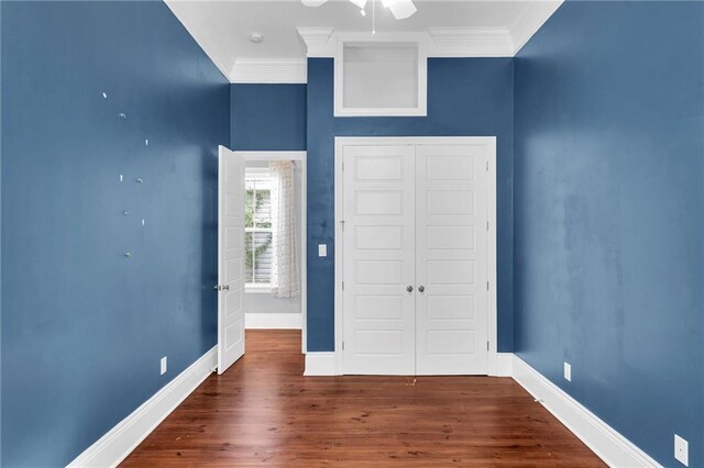 2540 Saint Ann St, New Orleans, LA 70119 - unfurnished bedroom featuring crown molding, a closet, baseboards, wood finished floors, and ceiling fan