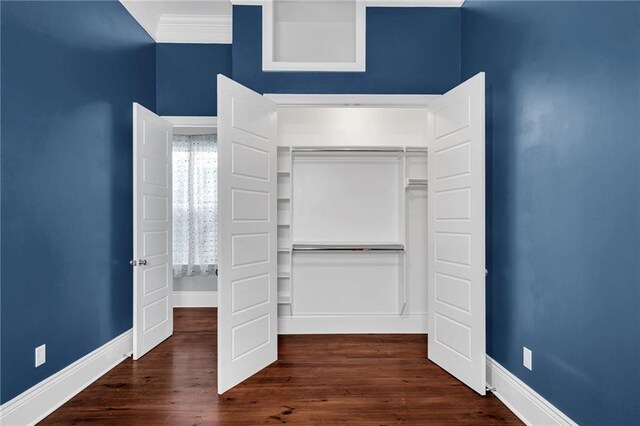 2540 Saint Ann St, New Orleans, LA 70119 - unfurnished bedroom with baseboards, a closet, dark wood-style floors, and ornamental molding