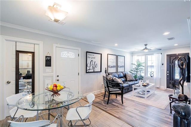 living room featuring light wood-style floors, baseboards, ceiling fan, crown molding, and recessed lighting