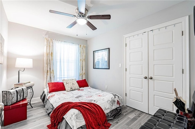 bedroom featuring light wood-type flooring, a closet, and ceiling fan