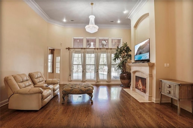 717 Tunica Bnd, Covington, LA 70433 - living room featuring ornamental molding, baseboards, wood finished floors, and a fireplace