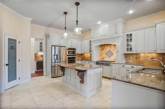 717 Tunica Bnd, Covington, LA 70433 - kitchen with stainless steel appliances, a sink, crown molding, dark stone countertops, and tasteful backsplash