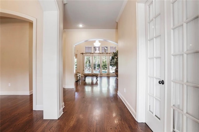 717 Tunica Bnd, Covington, LA 70433 - hall with arched walkways, ornamental molding, dark wood-type flooring, and baseboards