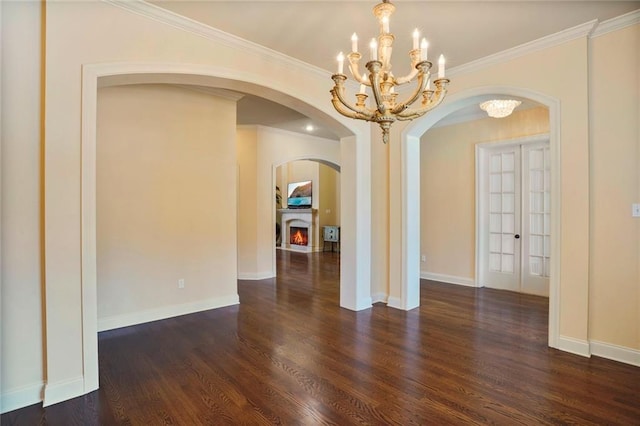 717 Tunica Bnd, Covington, LA 70433 - unfurnished room with a chandelier, wood finished floors, arched walkways, french doors, and ornamental molding