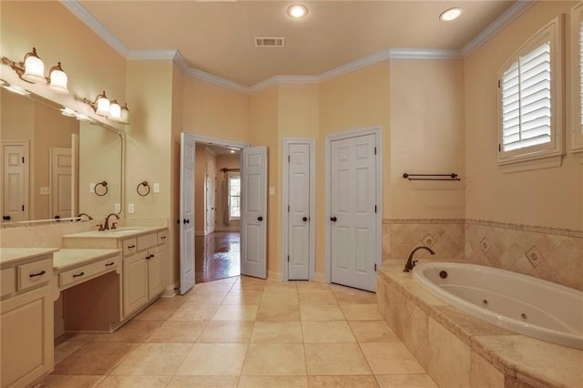 717 Tunica Bnd, Covington, LA 70433 - bathroom with a jetted tub, crown molding, vanity, recessed lighting, and tile patterned flooring
