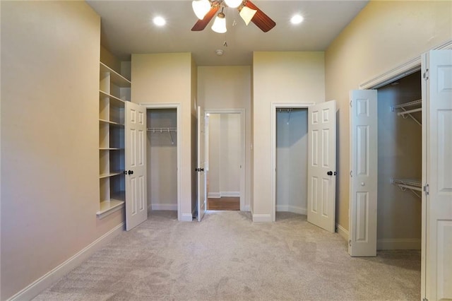 717 Tunica Bnd, Covington, LA 70433 - unfurnished bedroom with two closets, carpet, baseboards, and ceiling fan