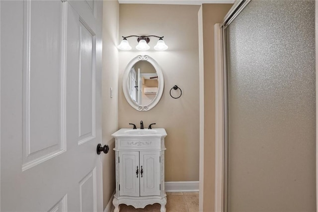 717 Tunica Bnd, Covington, LA 70433 - bathroom featuring vanity, tile patterned floors, baseboards, and a shower with door