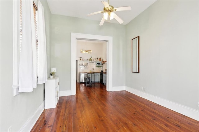 2748 Bienville St, New Orleans, LA 70119 - hallway with hardwood / wood-style floors, baseboards, and a sink