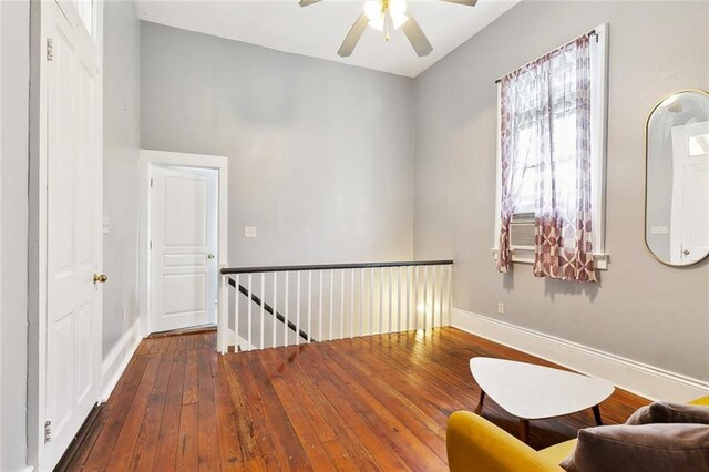 2748 Bienville St, New Orleans, LA 70119 - living area featuring an upstairs landing, a ceiling fan, wood-type flooring, and baseboards