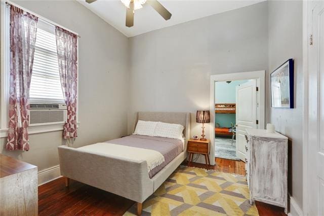 2748 Bienville St, New Orleans, LA 70119 - bedroom with wood finished floors, cooling unit, baseboards, and a ceiling fan