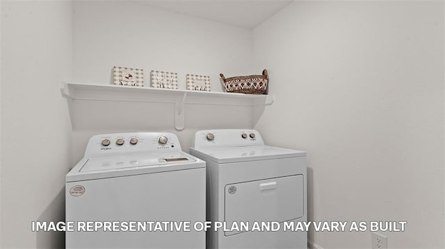 clothes washing area featuring separate washer and dryer
