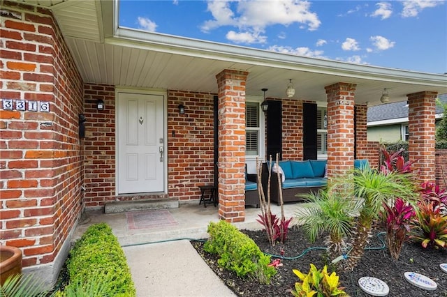 3316 N Labarre Rd, Metairie, LA 70002 - doorway to property featuring brick siding, a porch, and an outdoor living space