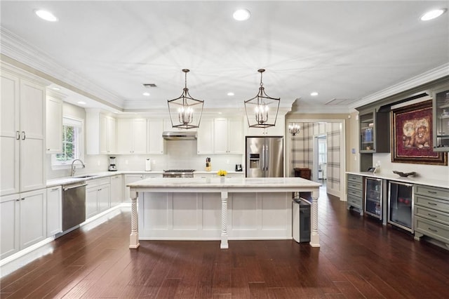 3316 N Labarre Rd, Metairie, LA 70002 - kitchen featuring stainless steel appliances, light countertops, wine cooler, a center island, and dark wood-type flooring
