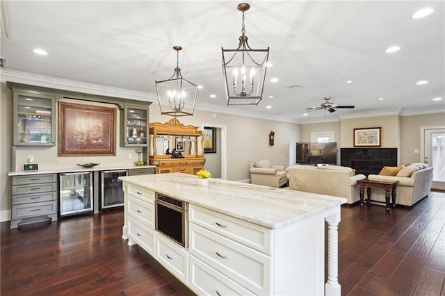 3316 N Labarre Rd, Metairie, LA 70002 - kitchen with wine cooler, decorative light fixtures, glass insert cabinets, dark wood-type flooring, and recessed lighting