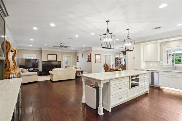 3316 N Labarre Rd, Metairie, LA 70002 - kitchen featuring crown molding, recessed lighting, light stone counters, a chandelier, and appliances with stainless steel finishes