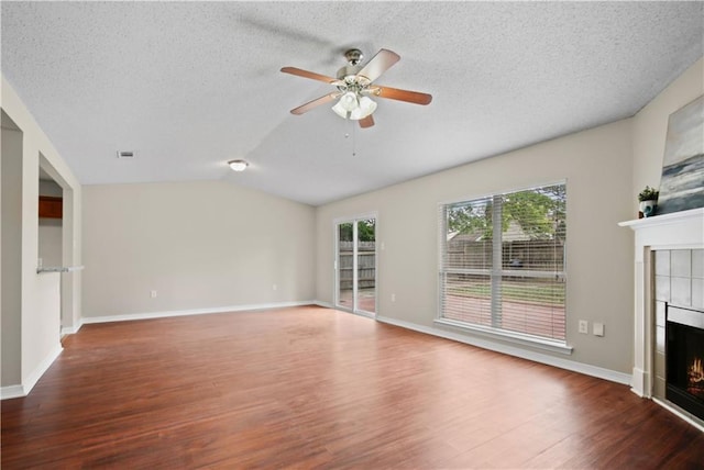 6705 Alisa Dr, Slidell, LA 70460 - unfurnished living room with a fireplace, wood finished floors, ceiling fan, lofted ceiling, and a textured ceiling