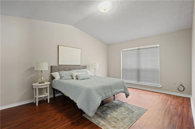 6705 Alisa Dr, Slidell, LA 70460 - bedroom featuring baseboards, vaulted ceiling, a textured ceiling, and wood finished floors