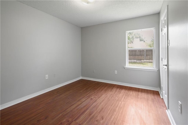 6705 Alisa Dr, Slidell, LA 70460 - unfurnished room with wood finished floors, a textured ceiling, and baseboards