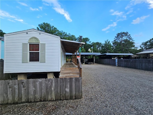 31668 Shelton Dr, Springfield, LA 70462 - view of side of property with gravel driveway and fence