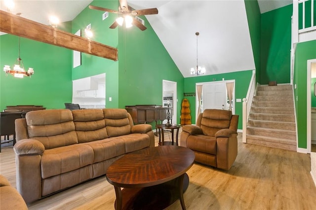 28189 Creole Rd, Lacombe, LA 70445 - living room with a chandelier, high vaulted ceiling, ceiling fan, wood finished floors, and stairway