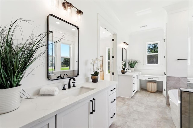 605 Northwoods Dr, Abita Springs, LA 70420 - full bathroom featuring plenty of natural light, two vanities, and a freestanding tub