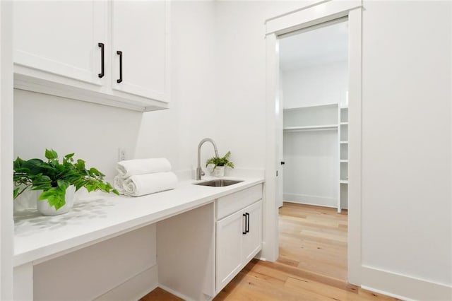 605 Northwoods Dr, Abita Springs, LA 70420 - bar area featuring a sink and light wood-style flooring
